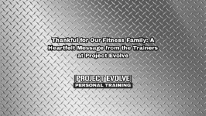 Project Evolve trainers smiling and holding pie with "Happy Thanksgiving" message in gym setting.