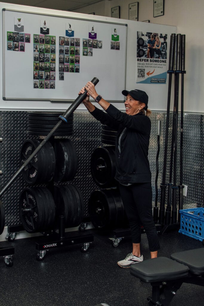 Naples personal training session with a member doing a landmine press